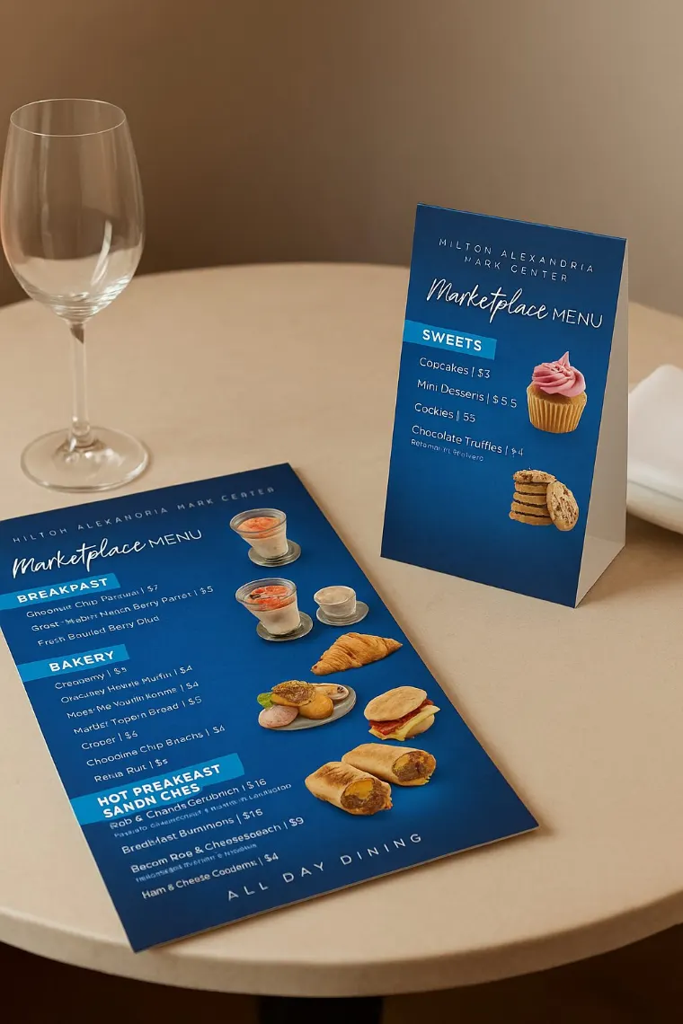 Marketplace menu table tent standing on a cafe table beside a printed menu