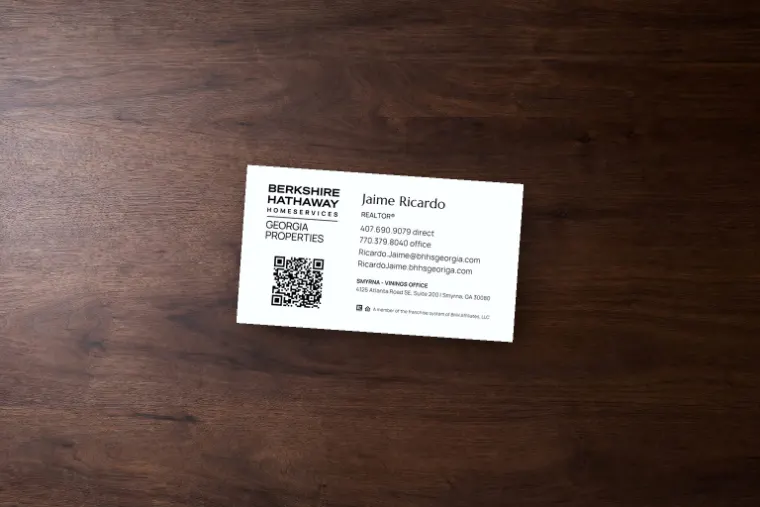 Jaime Ricardo business card mockup for Berkshire Hathaway HomeServices Georgia Properties on a dark walnut surface