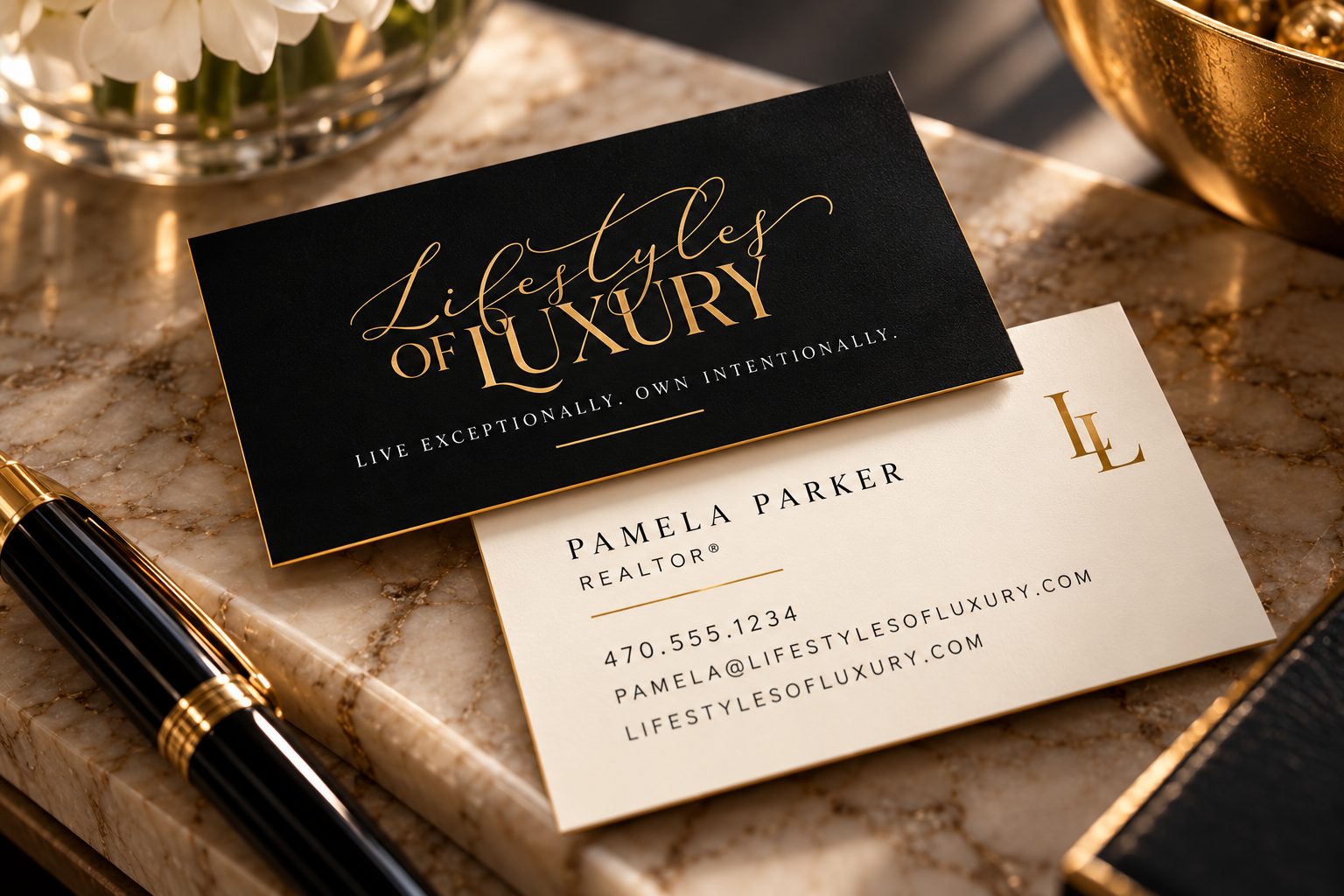 Lifestyles of Luxury business card mockup: a black card with the gold script logo over a cream card with Pamela Parker Realtor details, on a marble tray with a black and gold pen